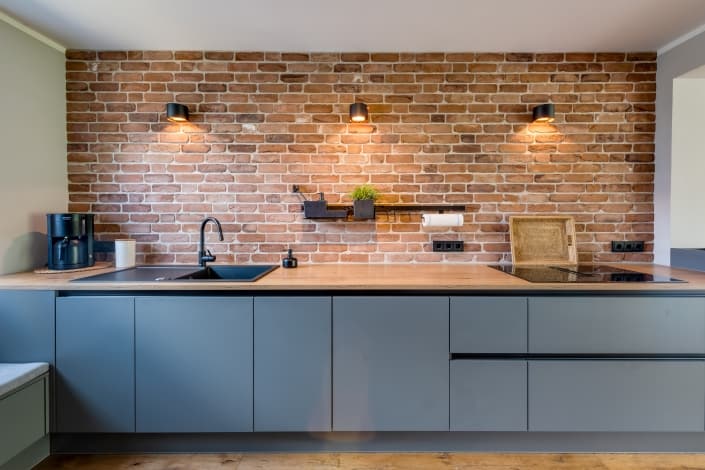 Bild einer Bauformat-Küche mit klaren Linien und schlichtem Design in Mauerwerkoptik, präsentiert vom Ellerbrock Küchenstudio Hamburg.